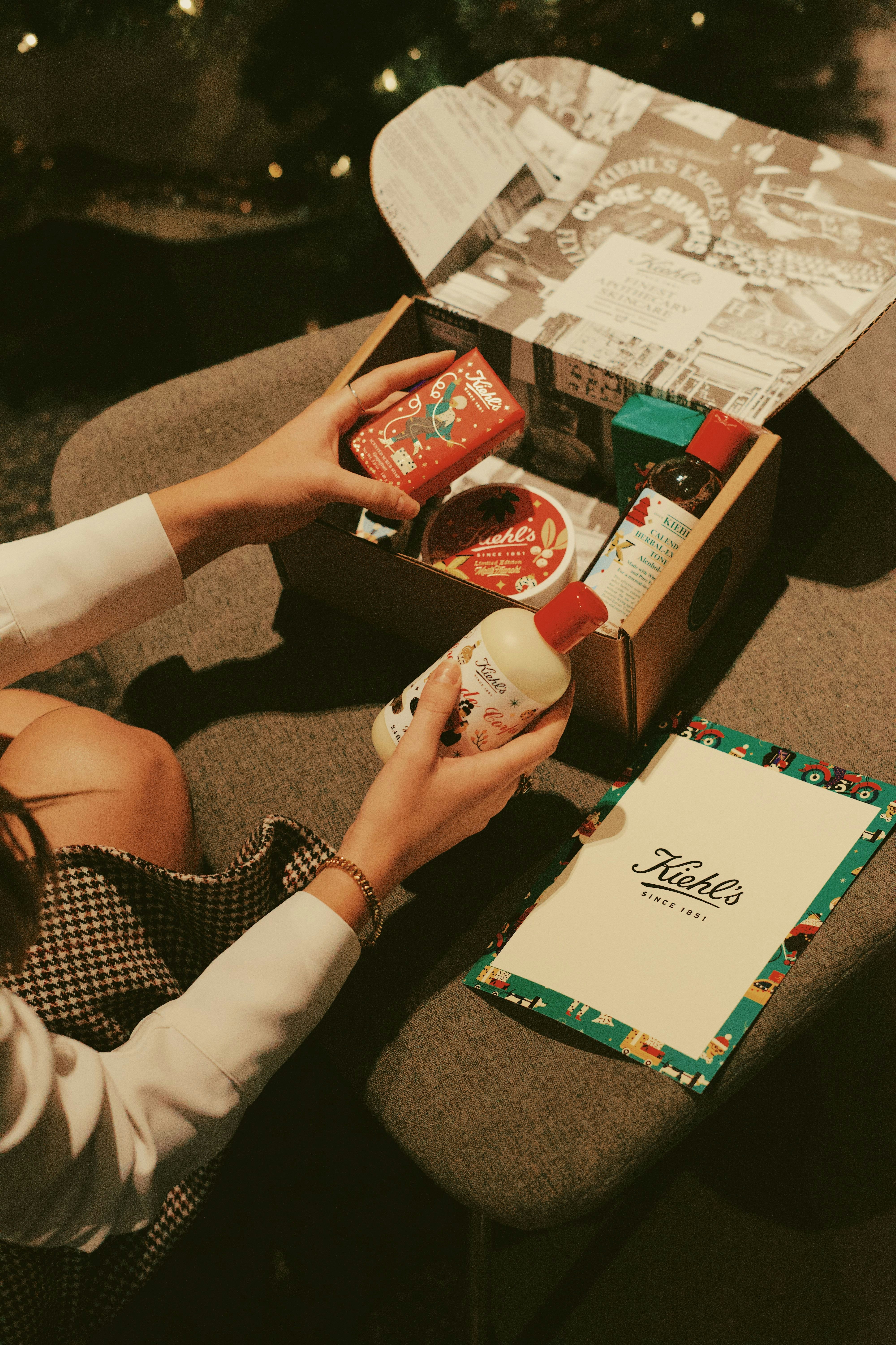 person holding red and white box